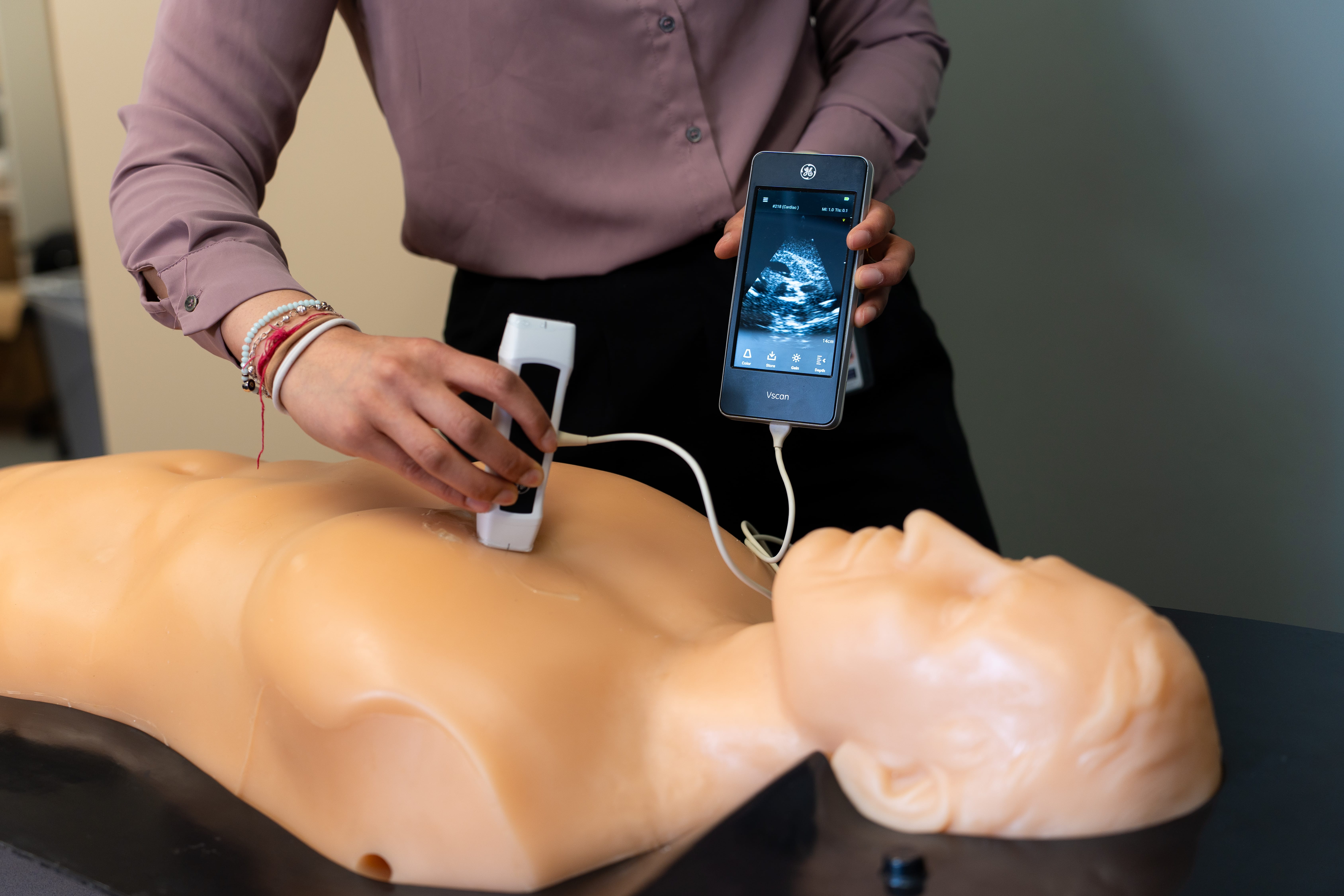 Handheld POCUS device being used